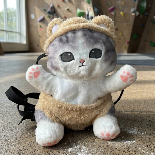 A mofusand cat chalk bag placed on the floor of an indoor climbing gym
